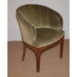 A green velvet upholstered shell back occasional tub chair.