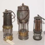 Three miners lamps, various.