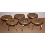 A set of six Indian enamelled brass three legged stools.