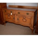 An early 20th Century walnut bowfront sideboard.