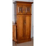 An early 20th Century Arts & Crafts walnut floor standing cupboard.