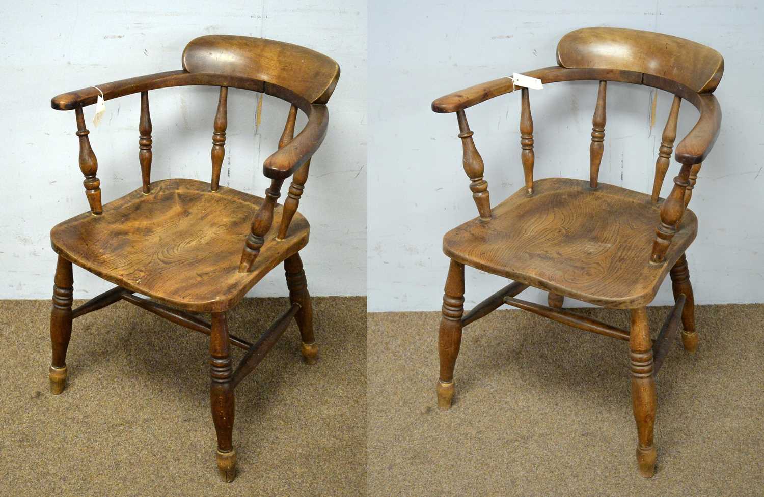 A pair of elm seated tub smokers bow armchairs.