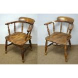 A pair of elm seated tub smokers bow armchairs.