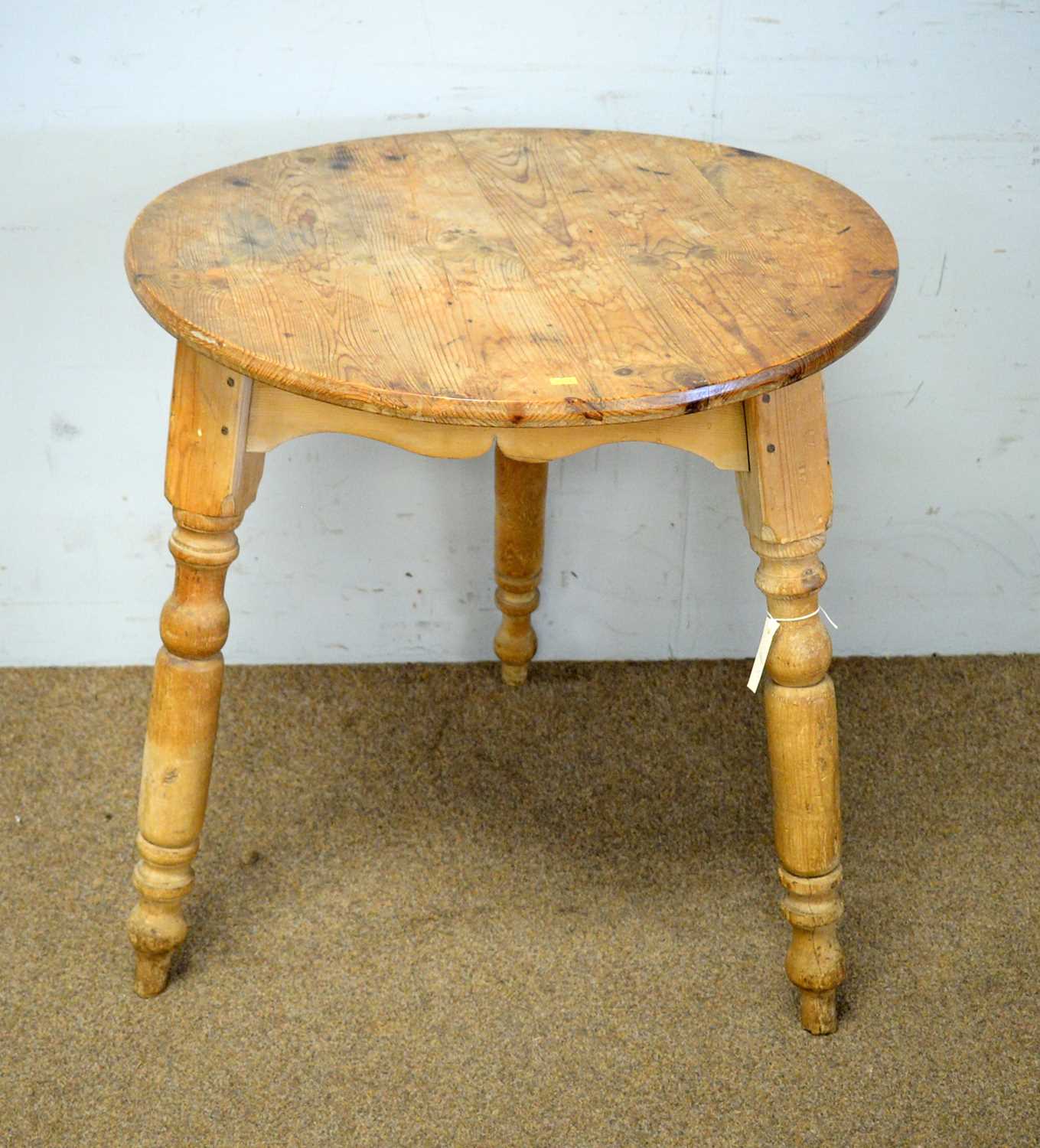 A circular pine cricket table