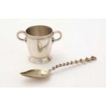 A silver egg cup and spoon.