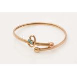 An Edwardian style 9ct yellow gold and turquoise bangle