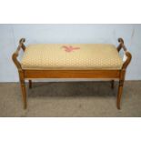 An Edwardian walnut and banded duet piano stool.