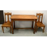 Victorian oak side table together with a pair of similar chairs.