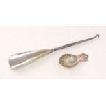 A silver caddy spoon and shoe horn.