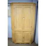 A 19th Century pine floor standing corner cupboard