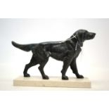 A patinated bronze figure of a dog