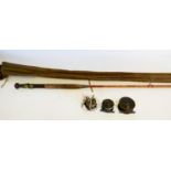 A selection of three vintage fishing reels and a fishing rod, in soft case.