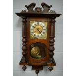 A mahogany drop dial wall clock