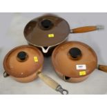 Three various Le Crueset saucepans.