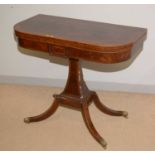 A late Regency style figured mahogany foldover games table