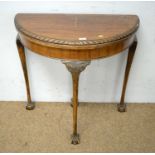 A mahogany D-shaped console table