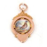 A 9ct yellow gold and enamel pigeon racing fob medal,