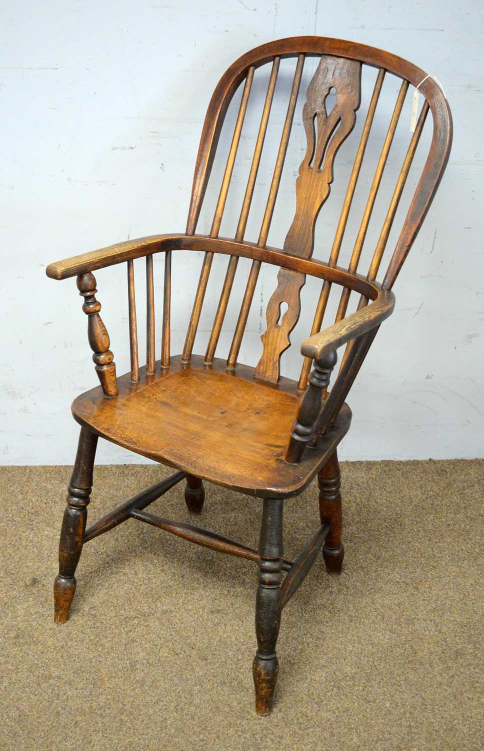 A ash and elm Windsor armchair with stretcher.