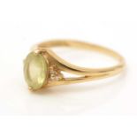 A yellow gemstone and diamond ring,