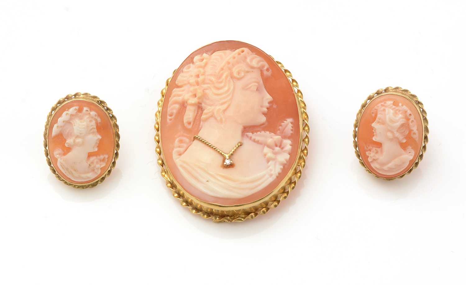 A carved shell cameo brooch, and matching earrings
