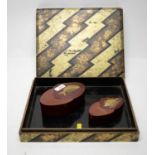 A pair and a single Japanese lacquered wood box.