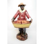 A ceramic Majolica figure of a man.