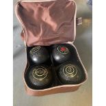 A set of four Thomas Taylor ‘solitaire’ lawn bowls.