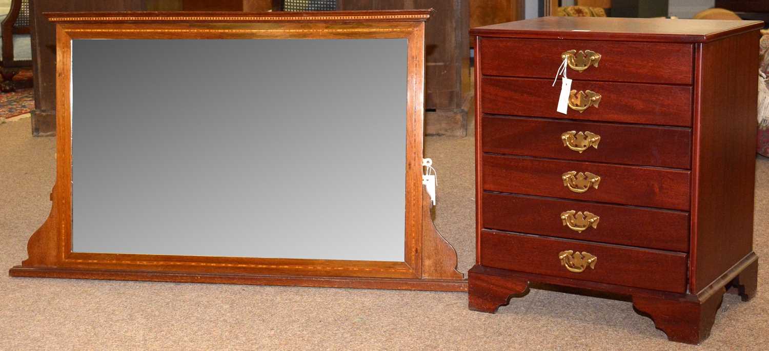 An Edwardian overmantel mirror; and a John Austin Ltd music cabinet.