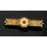 A Victorian Etruscan revival ruby and diamond set gold brooch,