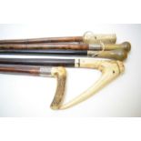 Two silver collared horn handled walking sticks and three others.