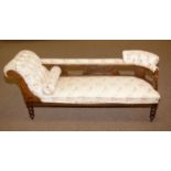 An Edwardian walnut sofa/chaise longue.