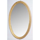 An early 20th Century gold painted oval mirror.