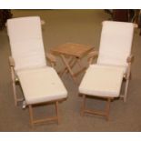 A pair of modern reclining garden chairs; and a folding table.