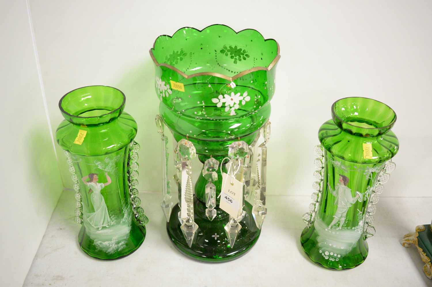 A Victorian green glass lustre, together with a pair of green and clear glass vases.