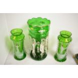 A Victorian green glass lustre, together with a pair of green and clear glass vases.