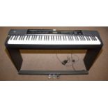 A Casio Privia PX–350M electric piano; and an associated stool.