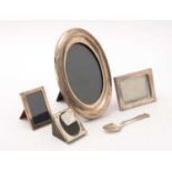 A selection of silver mounted photograph frames; and a silver sugar spoon.