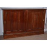 A large mahogany storage cupboard.