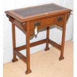 An Arts & Crafts oak writing desk.