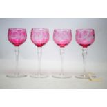 A set of four Edinburgh Crystal cranberry flash hock glasses.