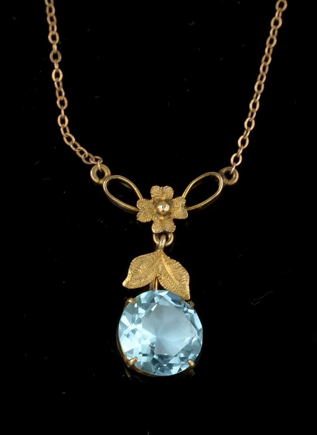 A blue glass and 9ct yellow gold pendant,