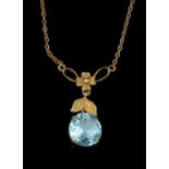 A blue glass and 9ct yellow gold pendant,