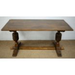 A mid 20th Century carved oak refectory style dining table.