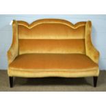 An early 20th Century gold plush upholstered serpentine fronted settee.