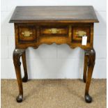 An 18th Century style ‘stressed’ and banded oak lowboy.