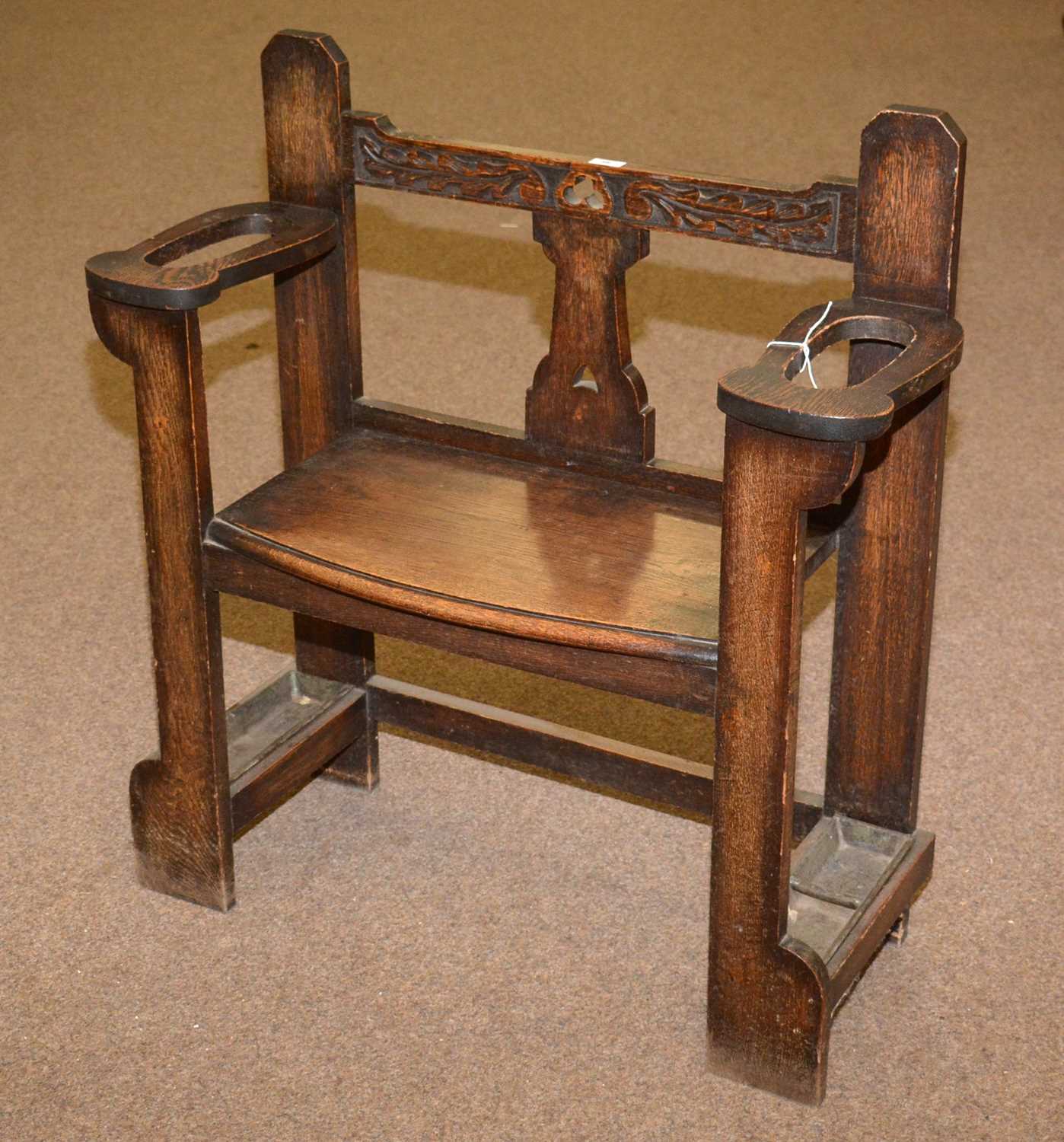 An early 20th Century carved oak hall seat/stick stand.