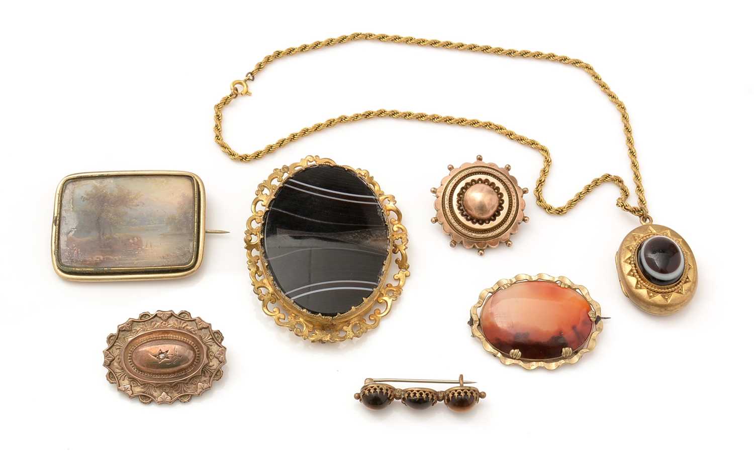 A selection of 19th Century gilt-metal pendants and brooches,