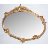 An attractive early 20th Century gold painted rococo style oval mirror.