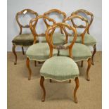 A set of six Victorian walnut balloon back chairs.