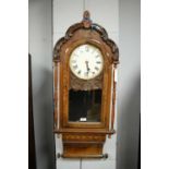 An American late 19th Century carved and inlaid walnut wall clock